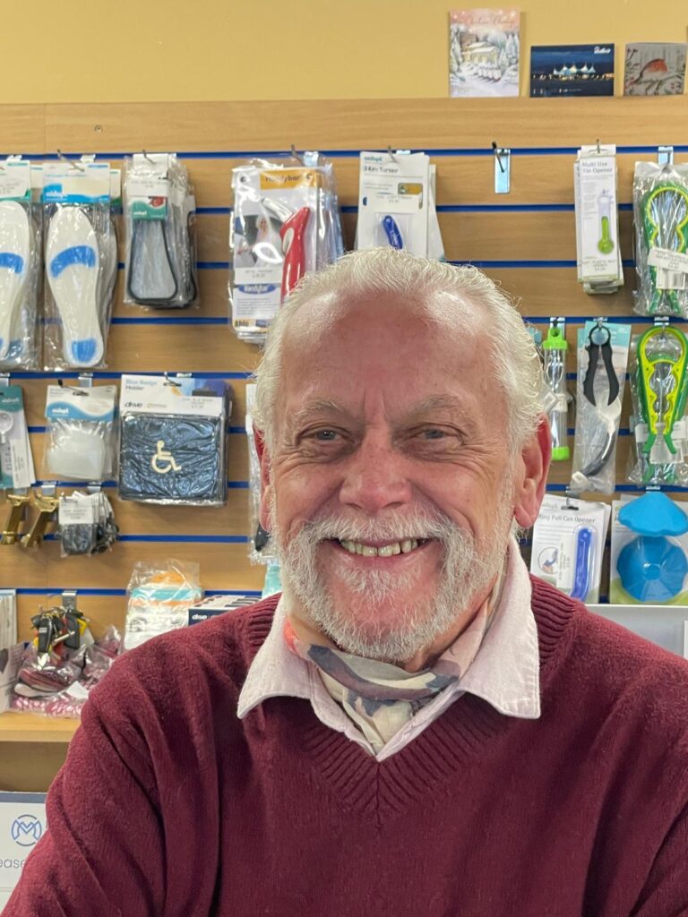A portrait of Karl Grouse, the founder of Redhill Shopmobility, whose dedication to local accessibility and independence launched our green and purple mission.